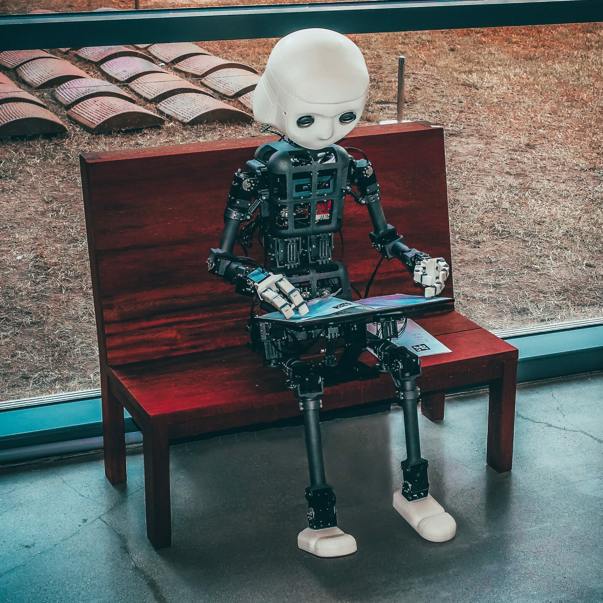 robot sitting on bench